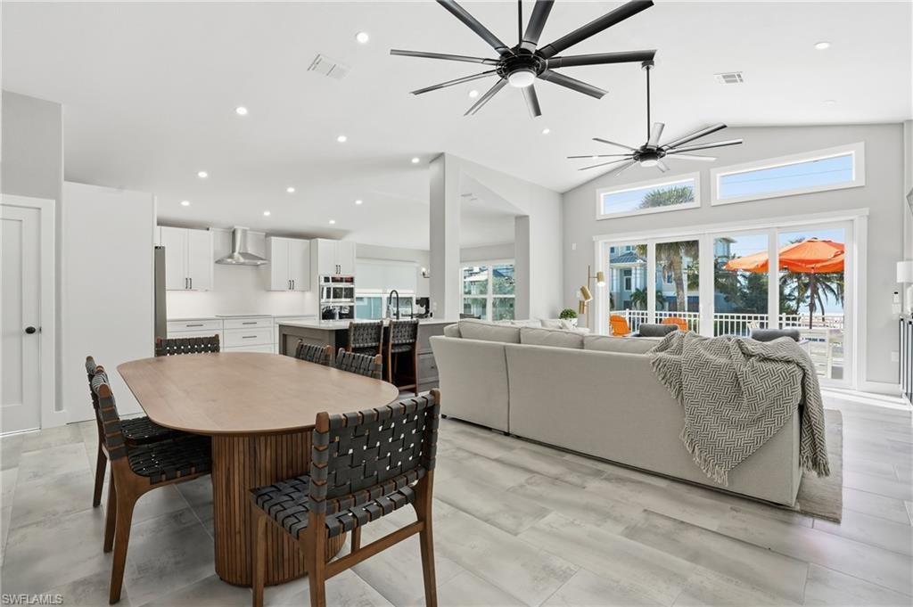 Dining area featuring recessed lighting, vaulted ceiling, and ceiling fan - Virtually Edited Image