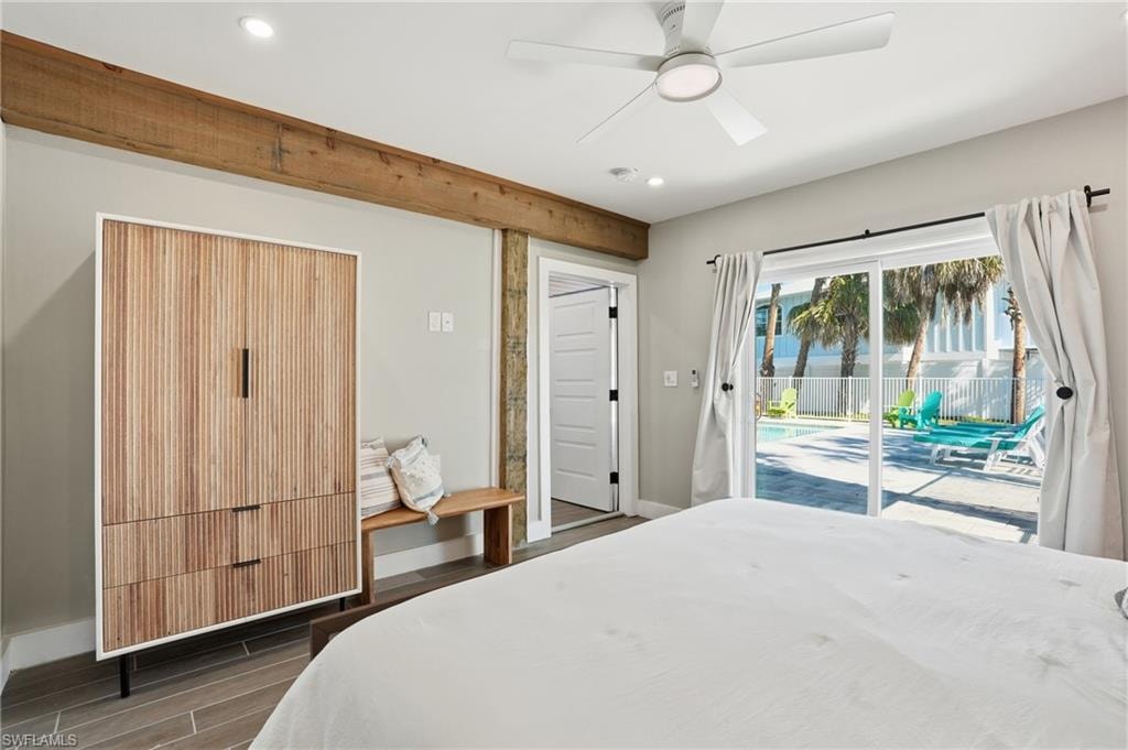 Bedroom with wood tiled floors, access to exterior, a ceiling fan, and recessed lighting - Virtually Edited Image