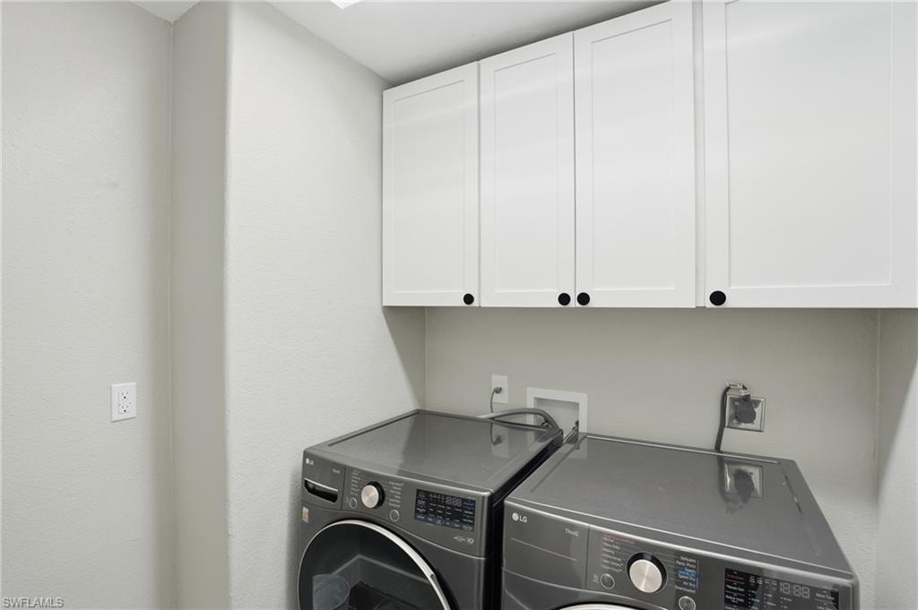 Laundry area featuring cabinet space and washer and dryer - Virtually Edited Image
