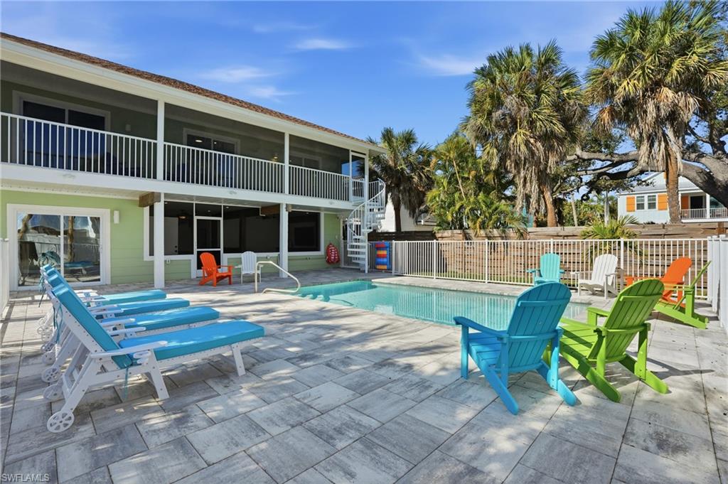 View of swimming pool featuring patio surround and a balcony - Virtually Edited Image