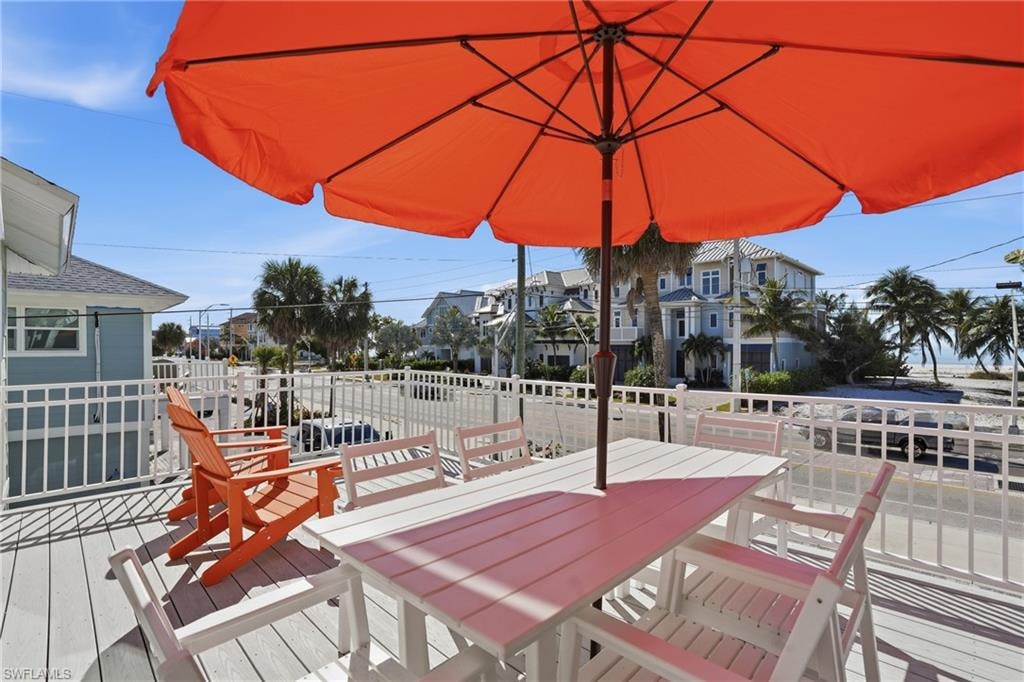 Wooden deck featuring outdoor dining area - Virtually Edited Image