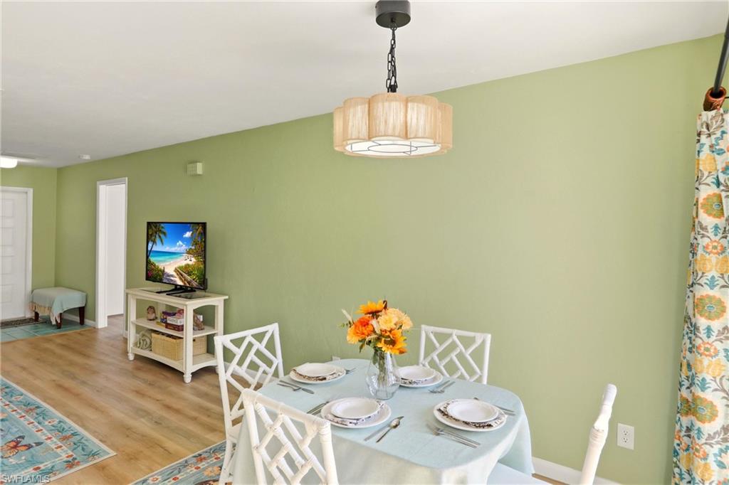 Dining space featuring wood finished floors and baseboards