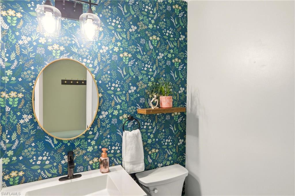 Half bathroom featuring toilet and a sink