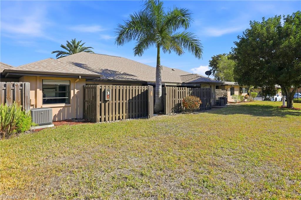Back of property with roof with shingles and stucco siding