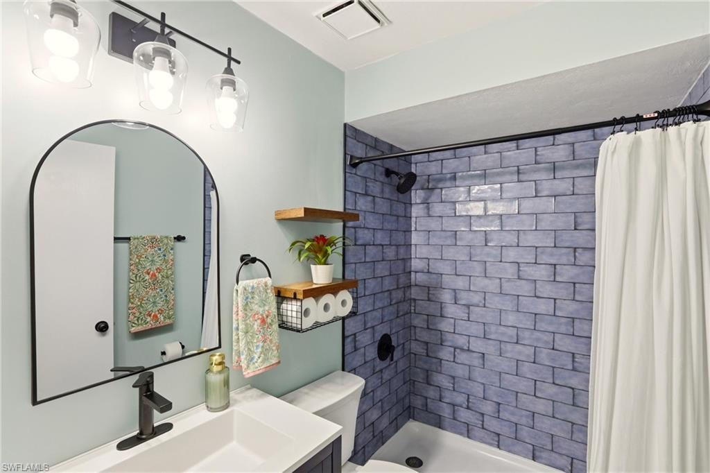 Full bath with vanity and a stall shower