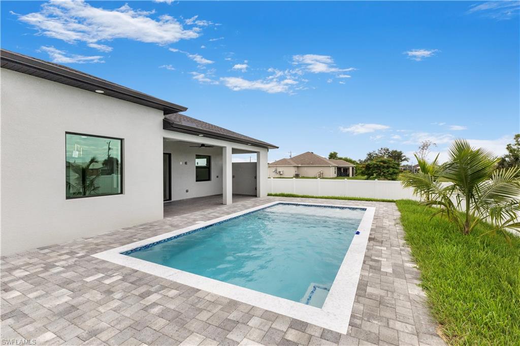 View of pool with patio surround and a fenced backyard