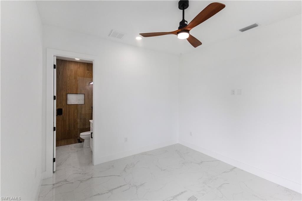 Unfurnished room with light marble finish floors, ceiling fan, and recessed lighting