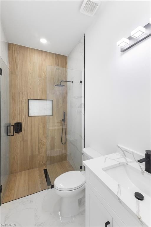 Full bathroom with a marble finish shower, vanity, and marble look tiles