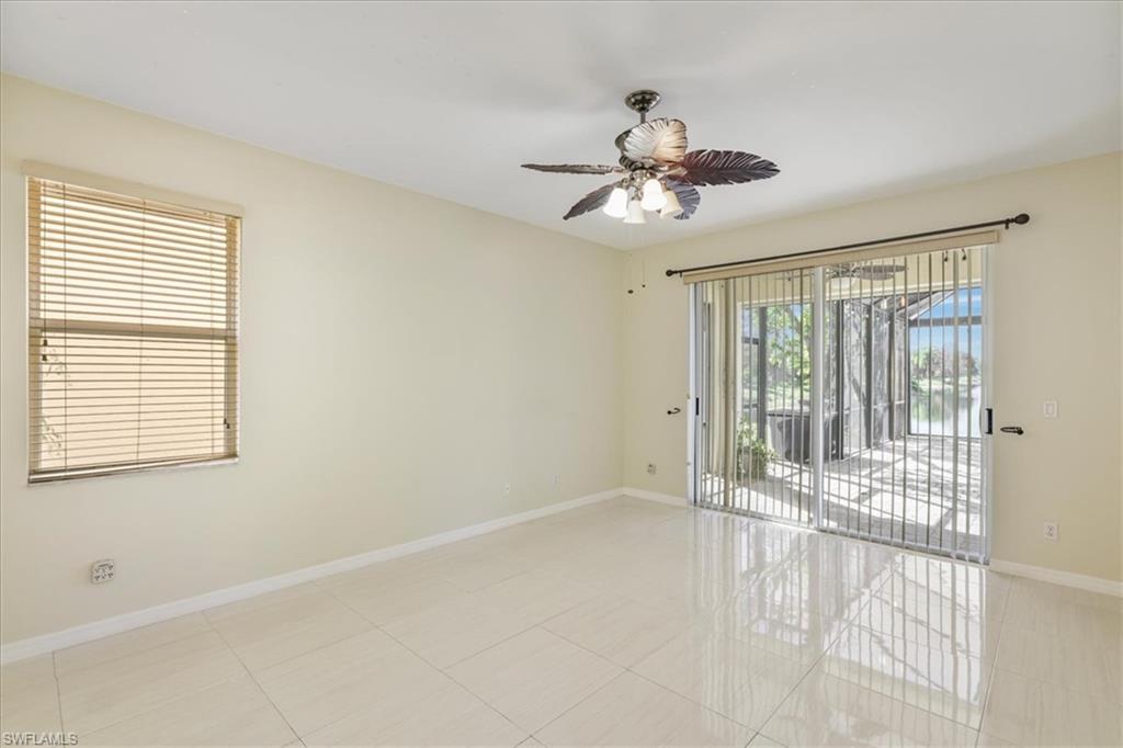 Unfurnished room with ceiling fan and light tile patterned flooring