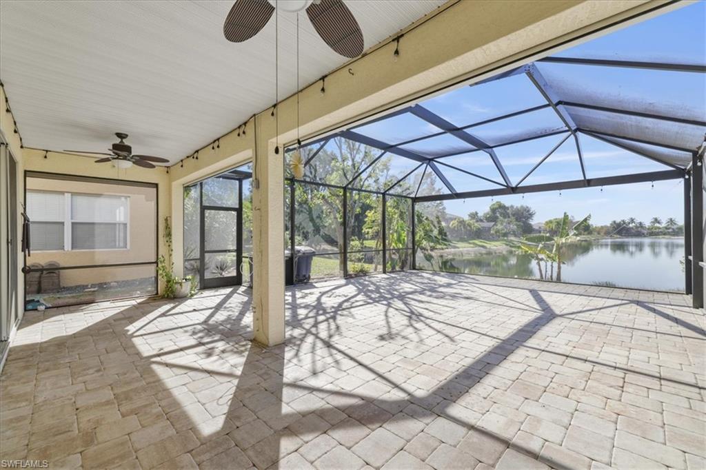 View of patio / terrace with ceiling fan, a sunroom, a lanai, and a water view