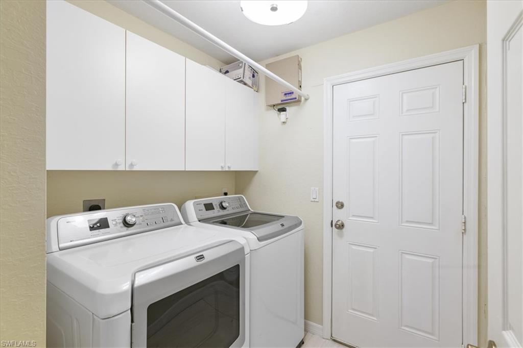Laundry room with washing machine and dryer and cabinet space
