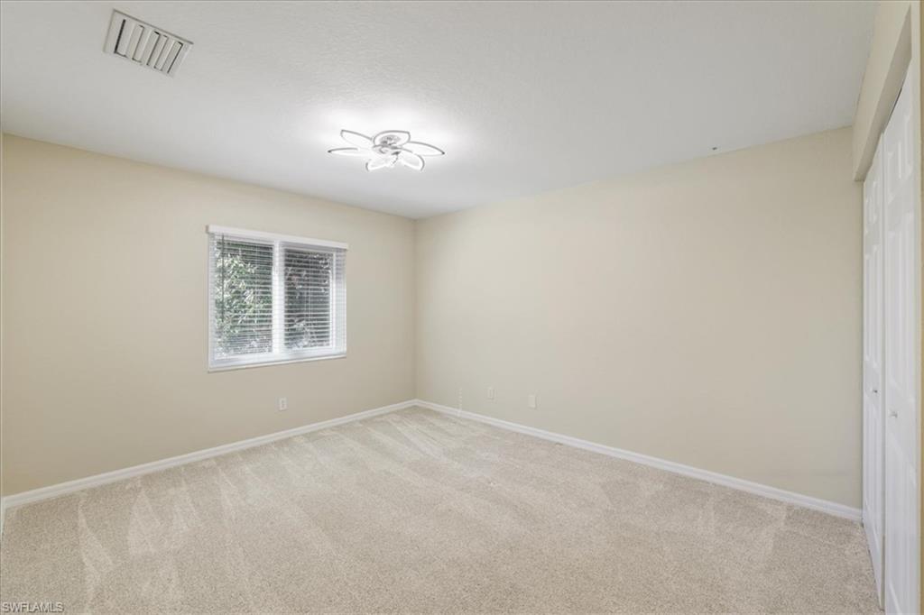 Empty room with light colored carpet