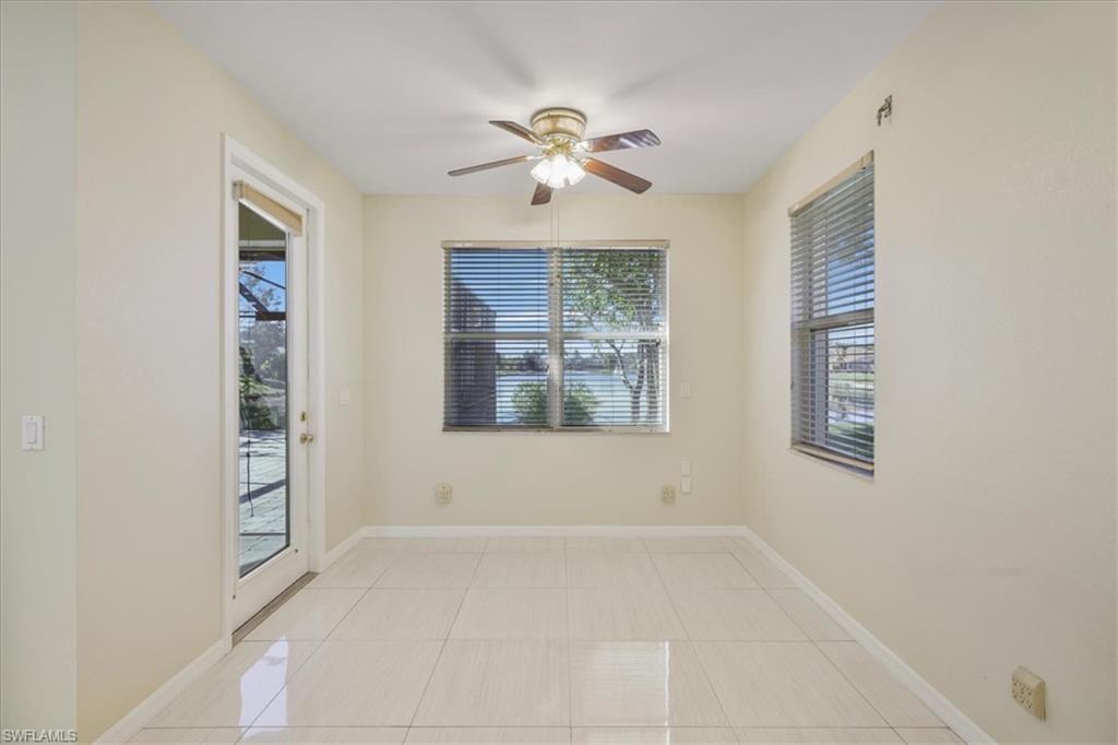 Spare room with ceiling fan and light tile patterned floors