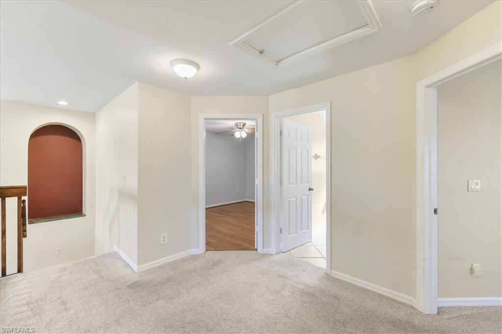 Empty room with light carpet and baseboards