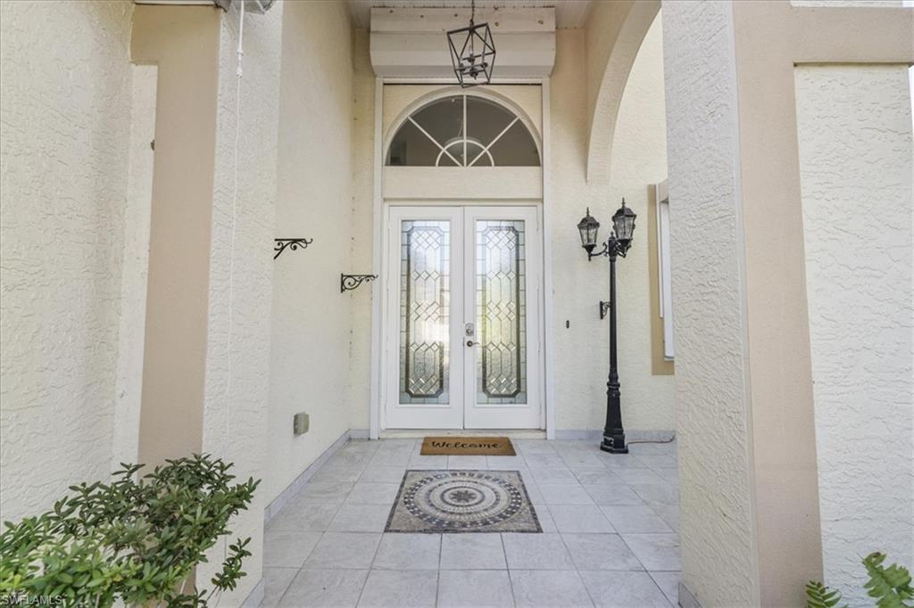 View of exterior entry with french doors and stucco siding