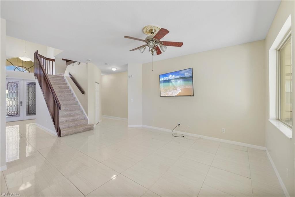 Unfurnished room with french doors, ceiling fan, and light tile patterned flooring