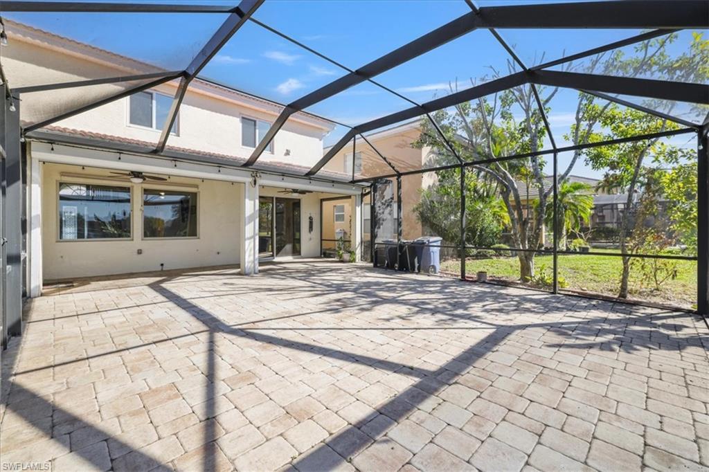View of patio with ceiling fan, a sunroom, and a lanai