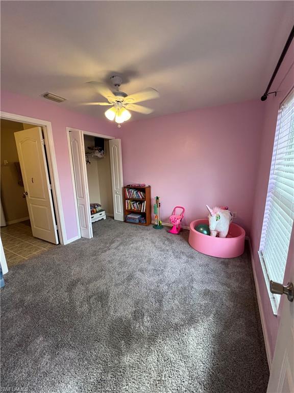 Game room featuring a ceiling fan and carpet floors