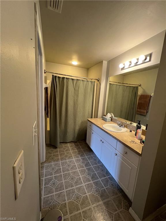 Bathroom with vanity and a shower with shower curtain