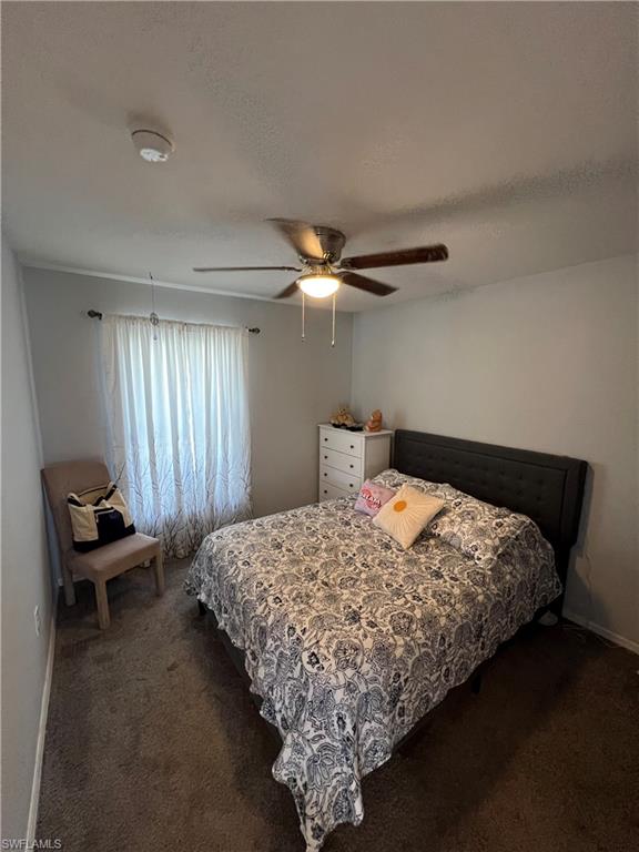 Bedroom featuring carpet and a ceiling fan