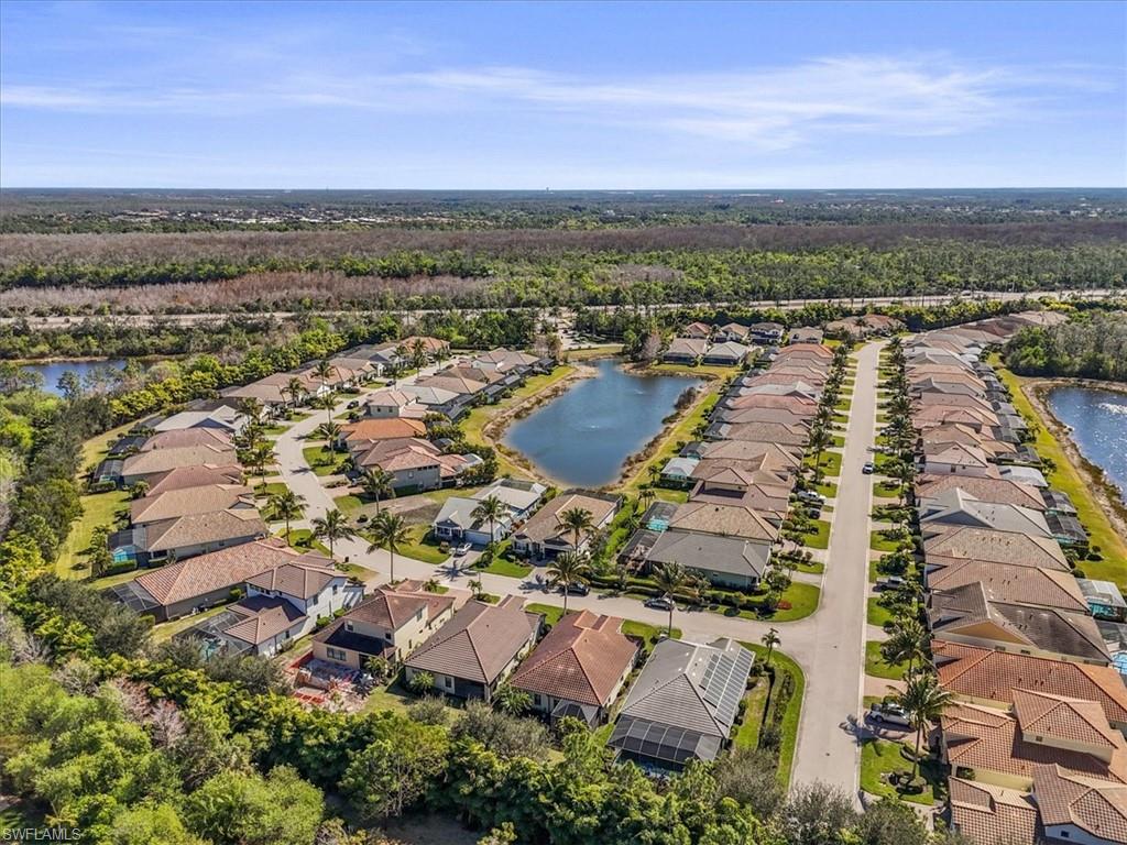 Aerial view of residential area featuring a large body of water