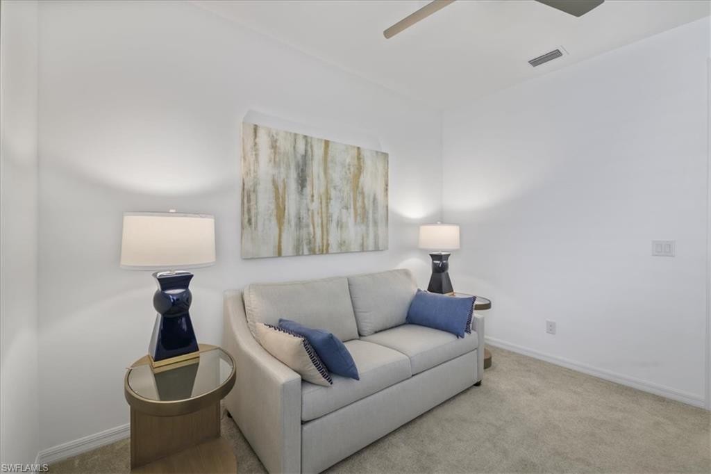 Living area featuring carpet flooring and a ceiling fan