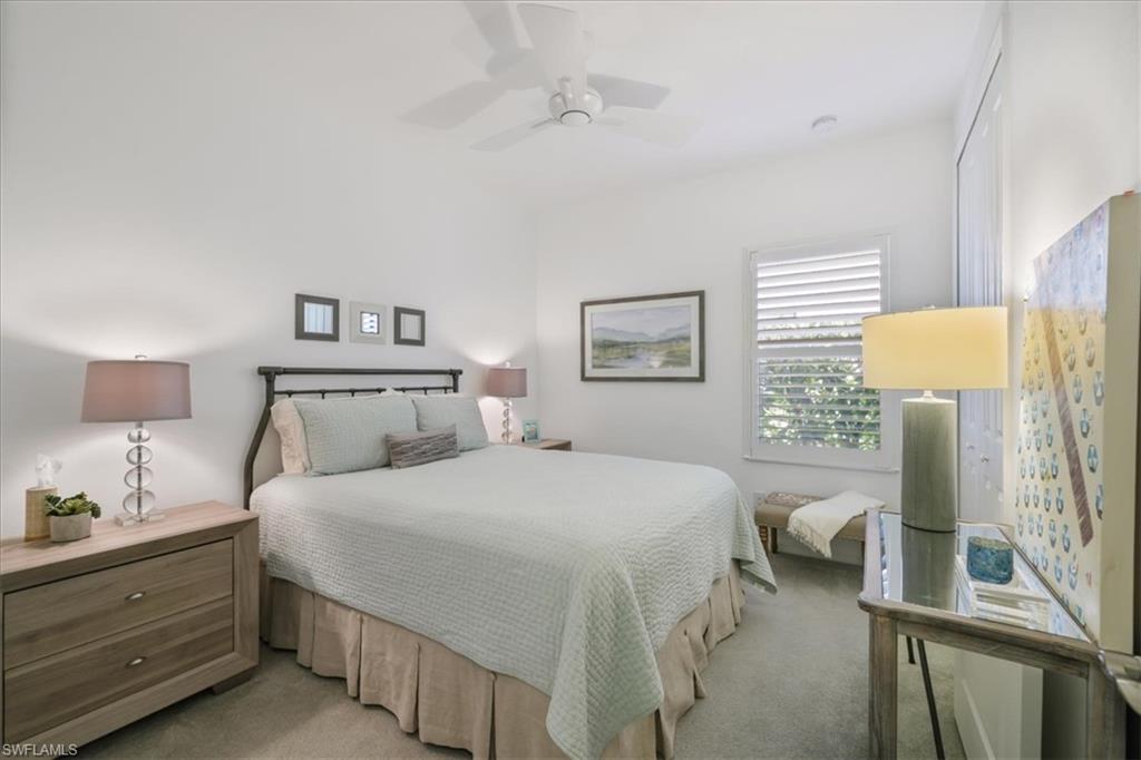 Bedroom featuring light carpet and ceiling fan