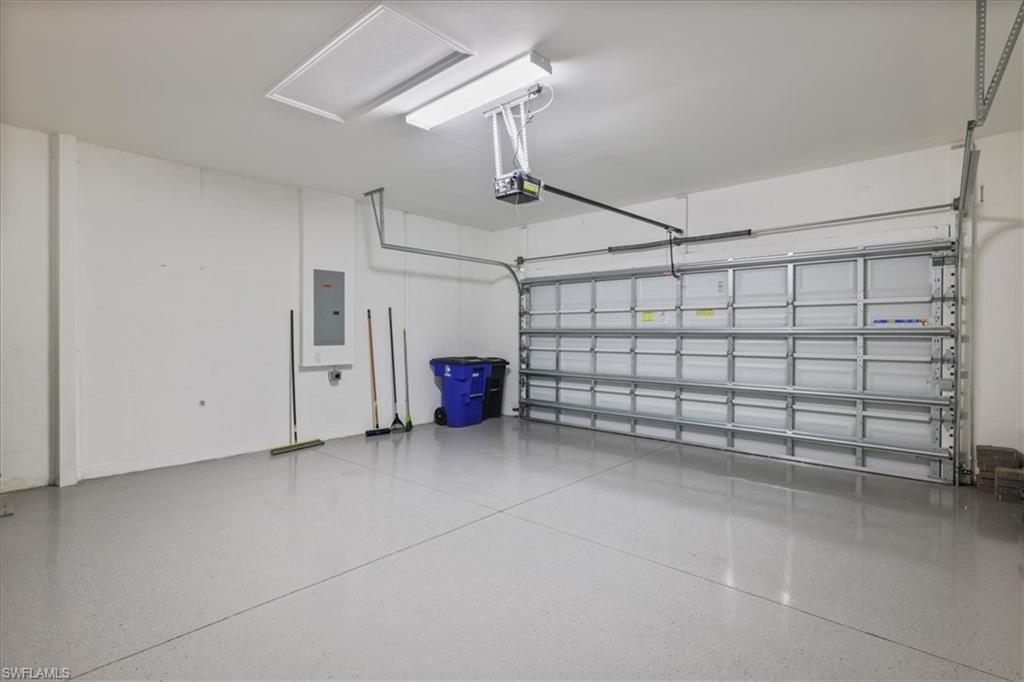 Garage with electric panel and a garage door opener