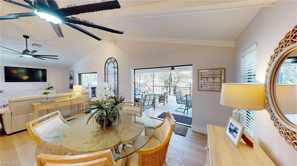 Dining and living area featuring an 80 inch TV