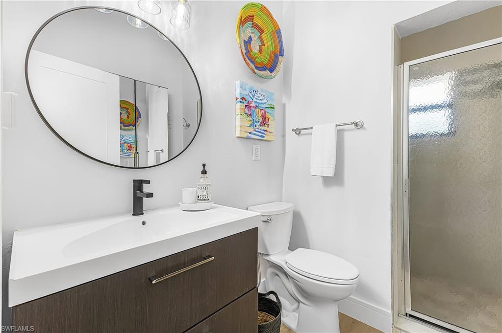 Full Bathroom with a walk-in tile shower, vanity and large mirrored armoire