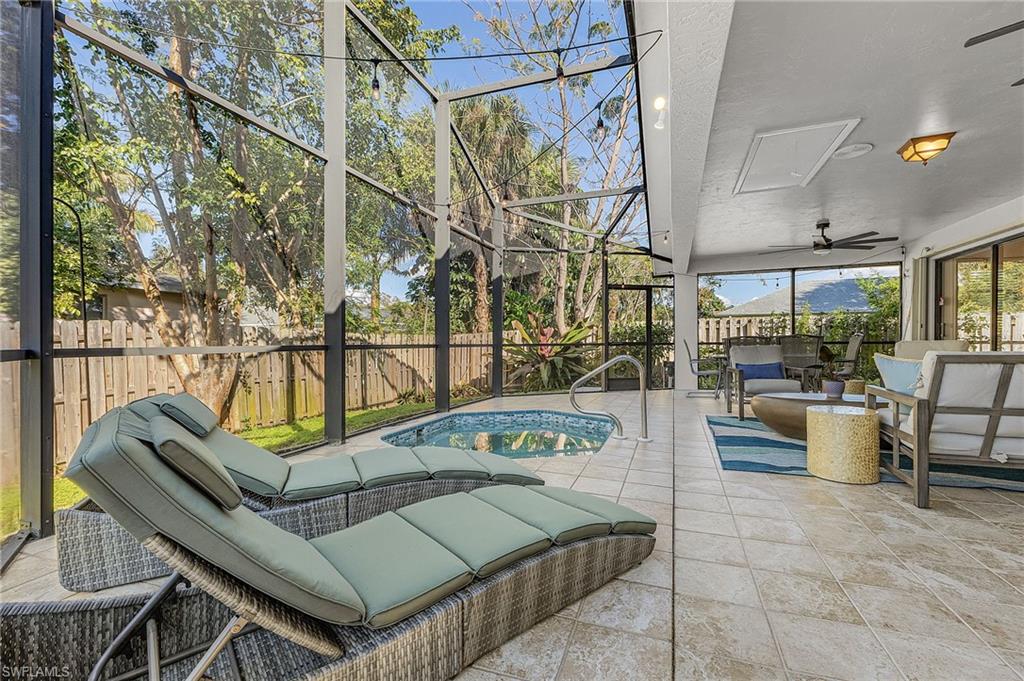View of  screened lanai featuring plunge pool/hottub, 2 sun loungers, 6 person dining table