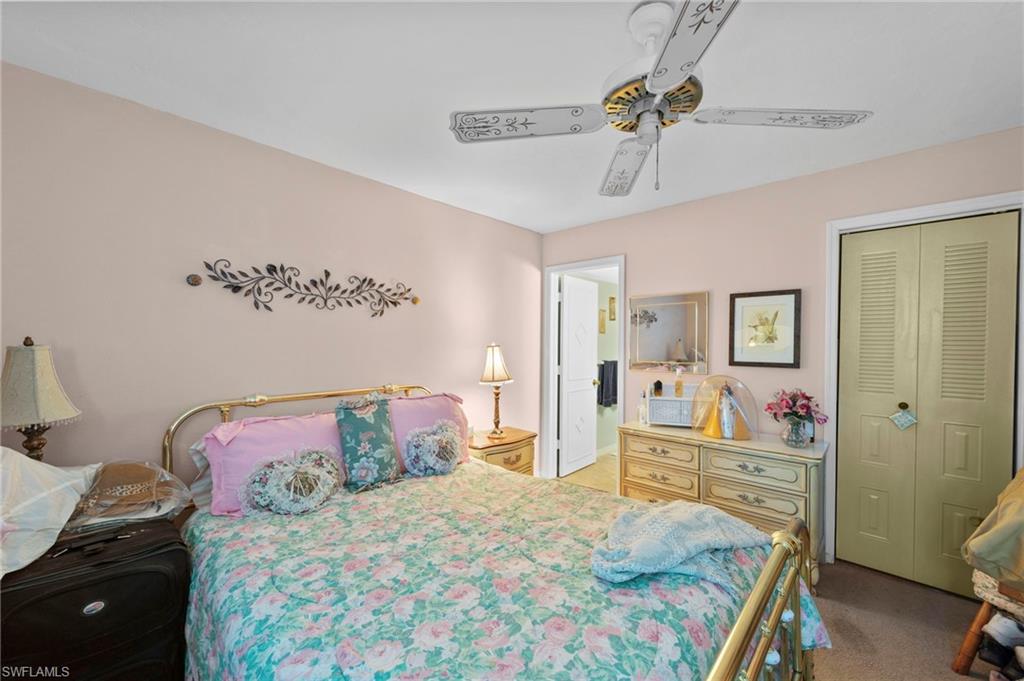Bedroom featuring a closet, ceiling fan, and light colored carpet