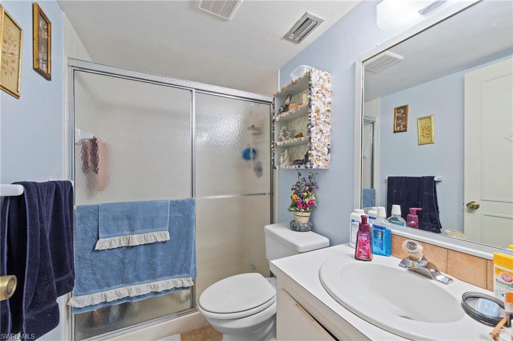 Bathroom with vanity and a stall shower