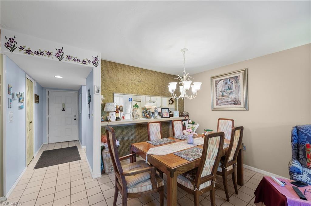 Dining room with a chandelier and light tile patterned flooring