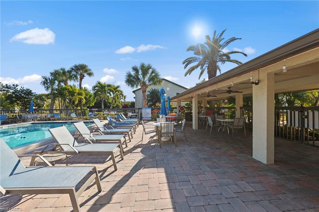 View of patio / terrace featuring ceiling fan, outdoor dining area, and a community pool