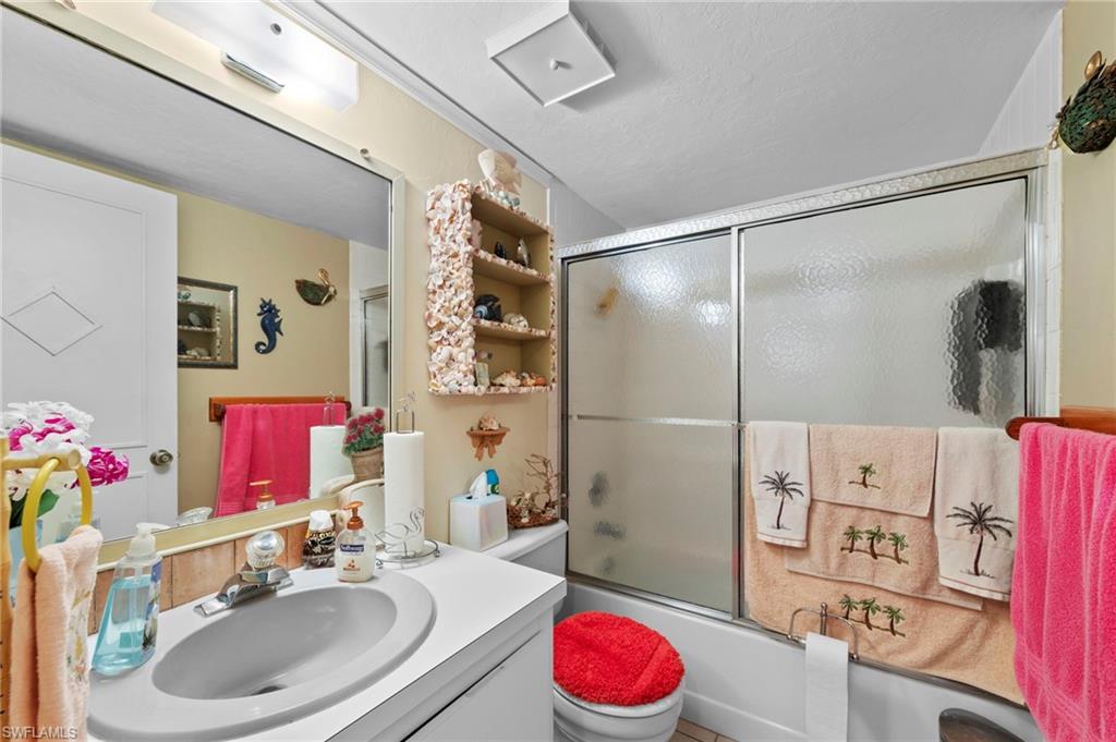 Full bathroom featuring vanity and combined bath / shower with glass door