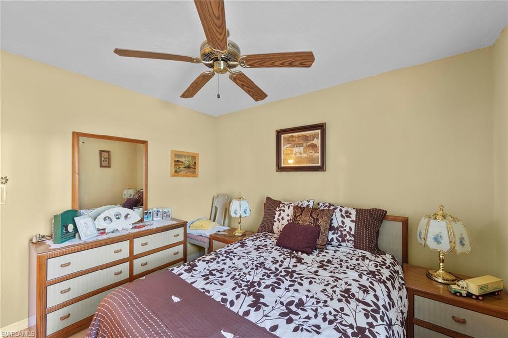 Bedroom featuring ceiling fan and baseboards