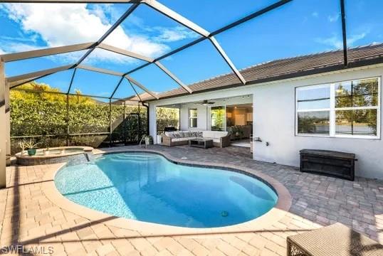Integrated pool / hot tub with an outdoor living space, a sunroom, a patio area, and a lanai