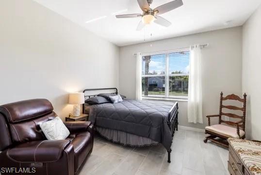 Bedroom with a ceiling fan and baseboards