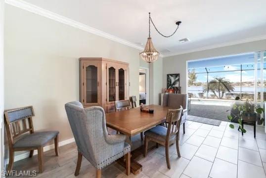 Dining room featuring crown molding and hanging lights