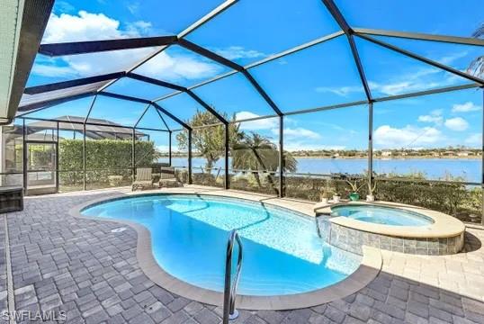Relaxing pool / spa featuring a sunroom, a patio, and a lanai