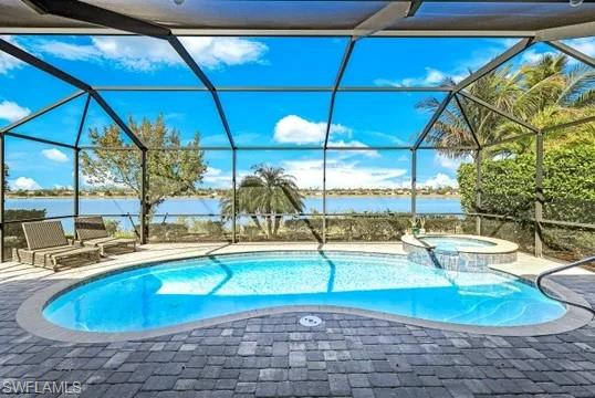 Relaxing pool / spa with a sunroom, a patio, and a lanai