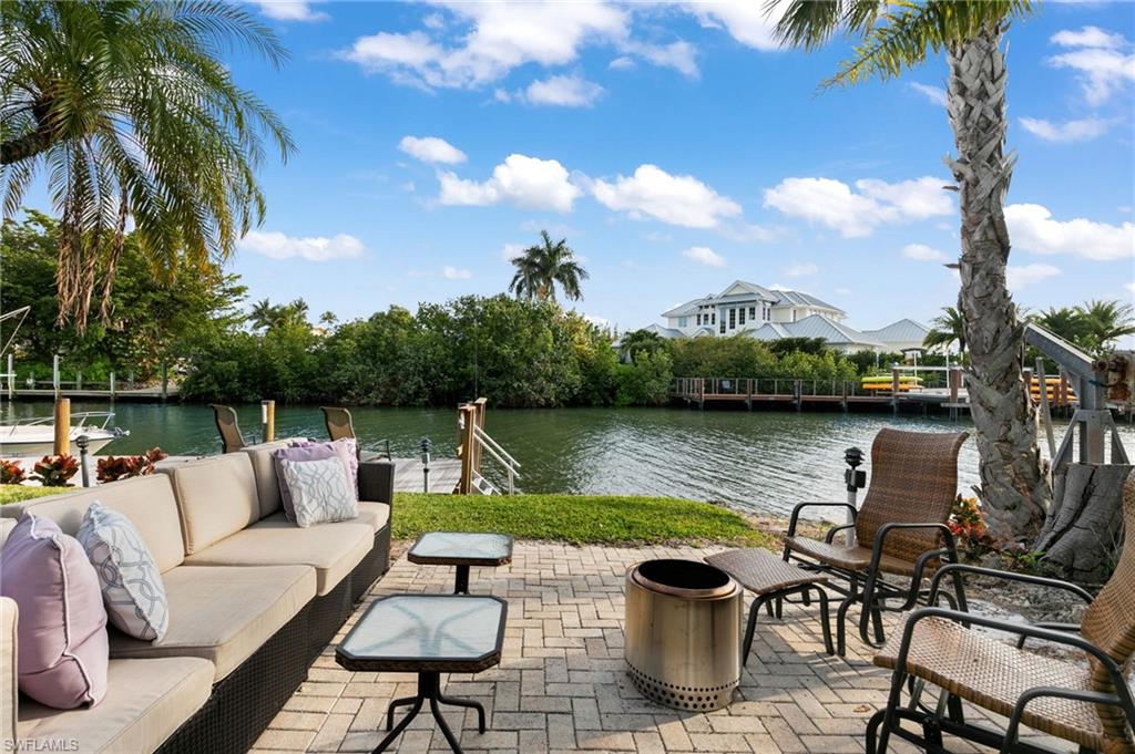 View of patio / terrace featuring a water view and an outdoor living space