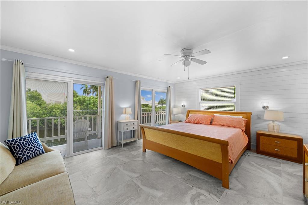 Bedroom with crown molding, access to exterior, multiple windows, and ceiling fan