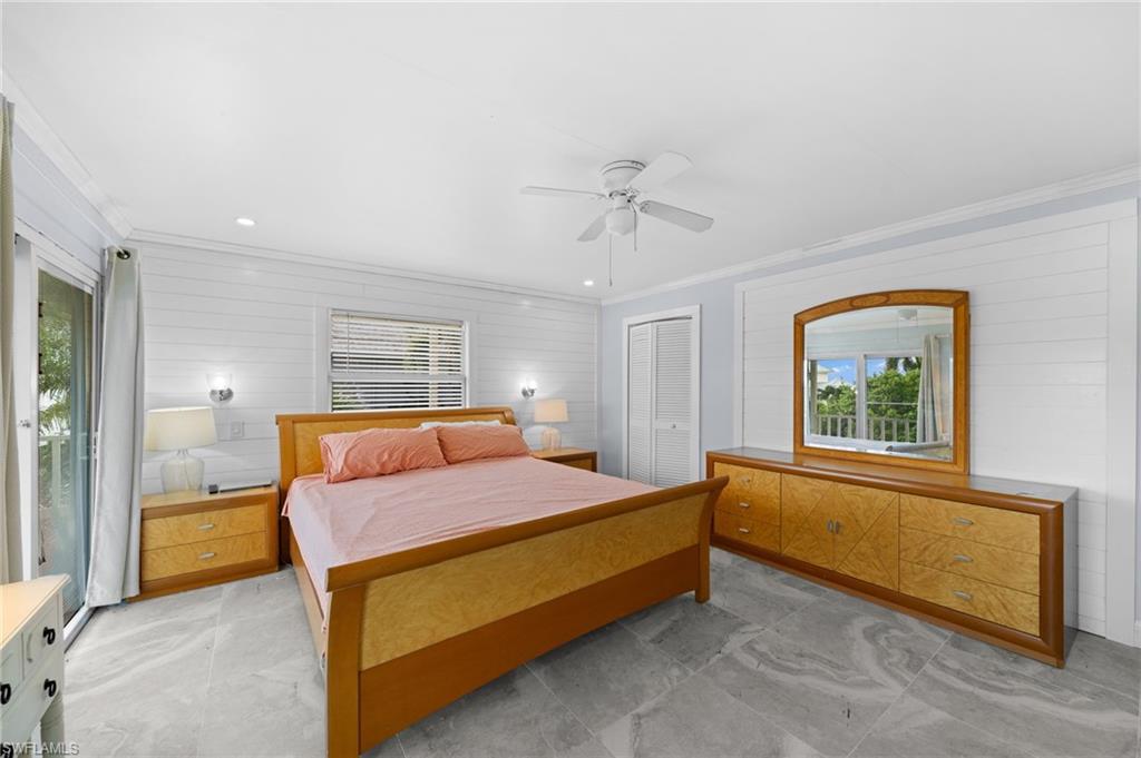 Bedroom featuring crown molding, ceiling fan, and a closet