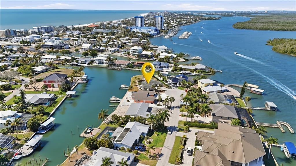 Aerial overview of property's location featuring a large body of water and nearby urban area - Virtually Edited Image