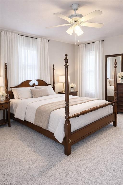 Bedroom with light carpet and a ceiling fan