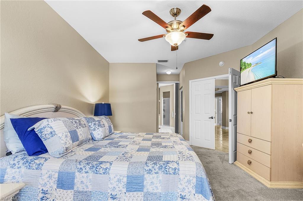 Bedroom featuring light carpet and a ceiling fan
