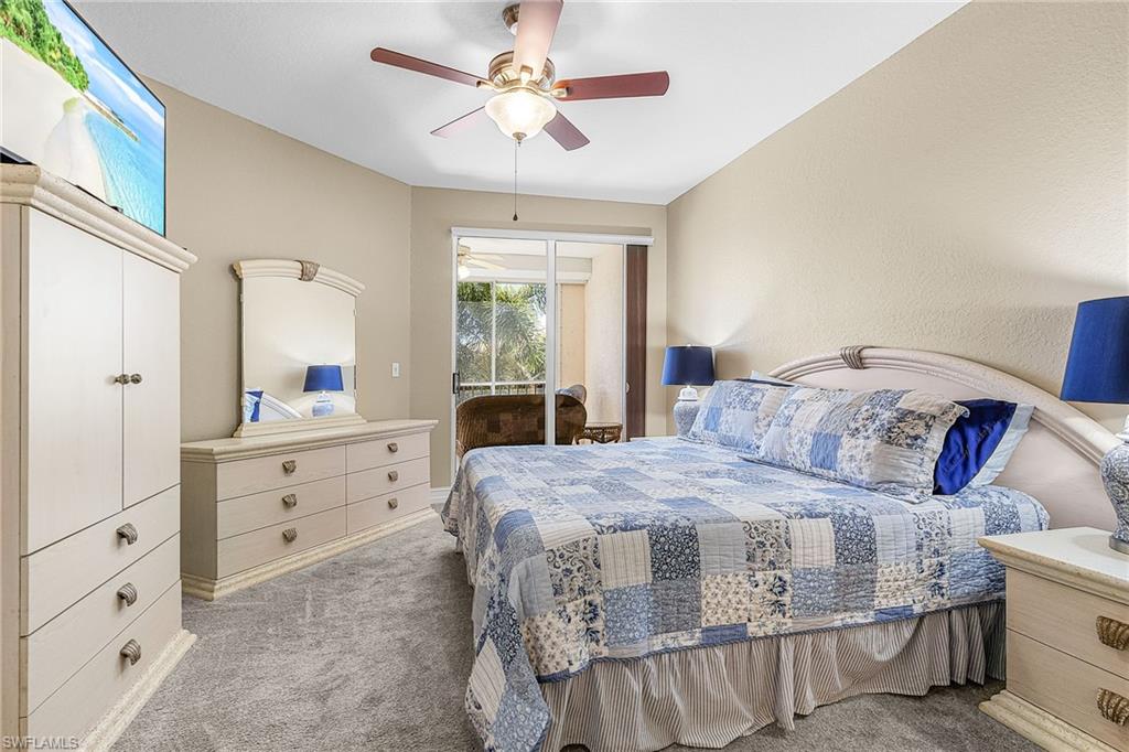 Bedroom featuring carpet flooring, a textured wall, a ceiling fan, and access to exterior