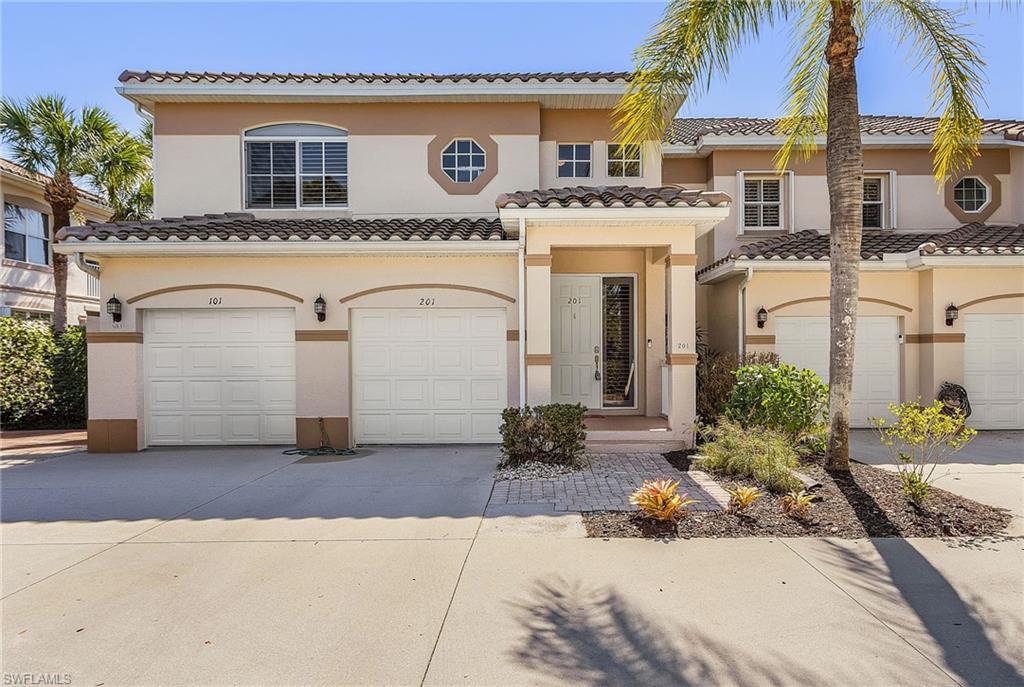 Mediterranean / spanish-style home featuring driveway, an attached garage, stucco siding, and a tile roof